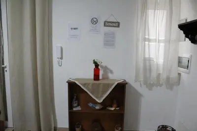 a shelf with a bottle on it next to a window at casa salusa in Terrasini