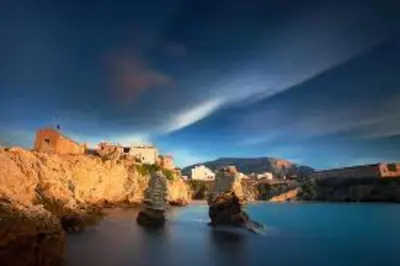 a group of rocks in a body of water at casa salusa in Terrasini