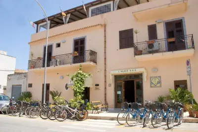 a group of bikes parked in front of a building at Agave Superior Rooms in San Vito lo Capo