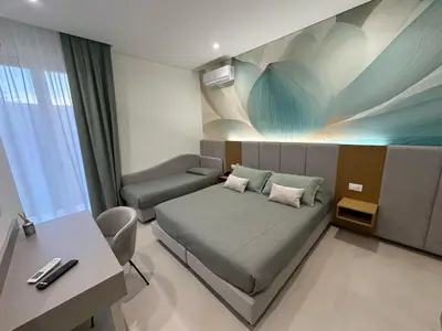 a hospital room with a bed and a desk at Agave Superior Rooms in San Vito lo Capo