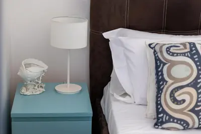 a bedroom with a bed and a chair in it at Villa Olimpia in Mondello