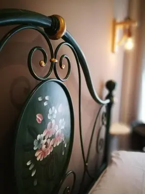 a mirror on the side of a bed with flowers at BELLA PALERMO in Palermo