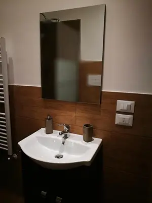 a bathroom with a white sink and a mirror at BELLA PALERMO in Palermo
