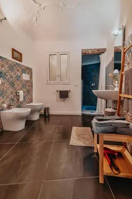 a bathroom with two sinks and two toilets at casaDamare in Palermo