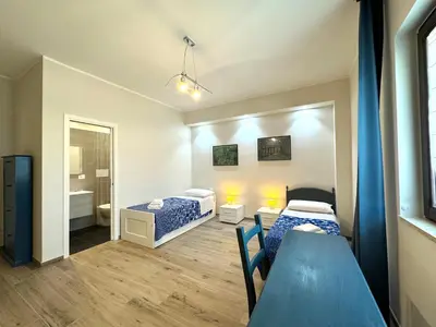 a small room with two beds and a bathroom at Casa di Mami in Capaci
