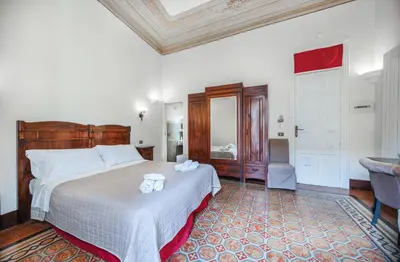 a bedroom with a bed with two towels on it at B&B Novecento in Palermo