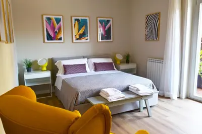 a bedroom with a bed and two chairs in it at REALE ORLEANS in Palermo