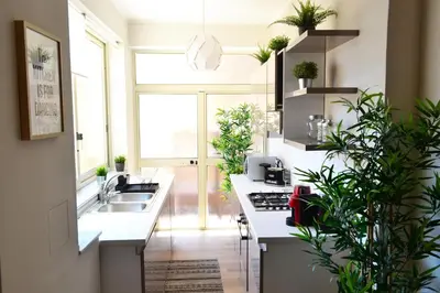 a kitchen with white counters and potted plants at REALE ORLEANS in Palermo
