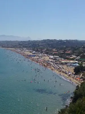 a group of people in the water at a beach at Casa Mimì in Castellammare del Golfo
