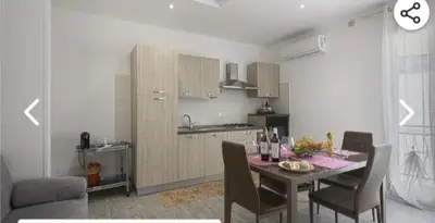 a kitchen with a table and chairs in a room at Appartamento solare in Castellammare del Golfo