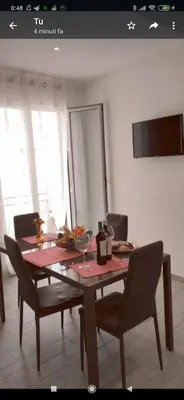 a dining room table with chairs and a red table cloth at Appartamento solare in Castellammare del Golfo