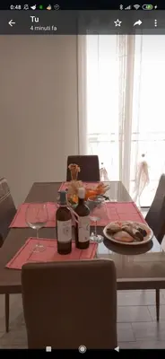 a table with two bottles and a plate of food at Appartamento solare in Castellammare del Golfo