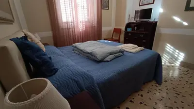 a bedroom with a blue bed with towels on it at Genio del Porto - Mabbonath in Palermo