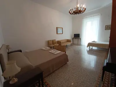 a bedroom with a bed and a living room at Genio del Porto - Mabbonath in Palermo