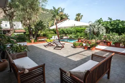 a patio with two chairs and a swimming pool at casa Morgana in Palermo