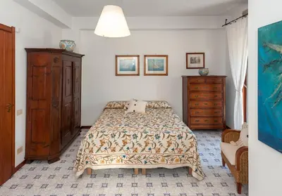 a bedroom with a bed and a dresser at casa Morgana in Palermo