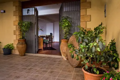 a hallway with potted plants on the floor at Piccolo Sole d'oro - appartamenti in Calatafimi