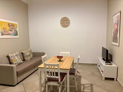 a living room with a table and a couch at Palermo Centre - Apartments with Private Balcony or Terrace in Palermo
