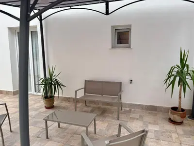 a room with chairs and a bench and a table at Palermo Centre - Apartments with Private Balcony or Terrace in Palermo