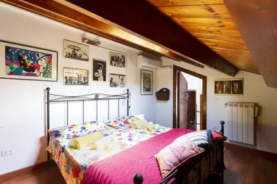 a large wooden door in a room with chairs at Anna's Home in Historical Center in Palermo