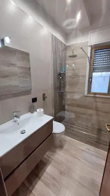 a bathroom with a toilet and a sink and a shower at Casa Vacanze L'isola del Relax in Isola delle Femmine
