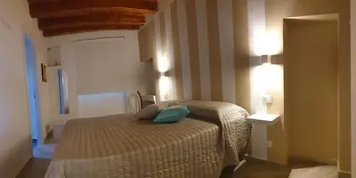a bedroom with a bed with a green pillow on it at Casa Margò in Monreale