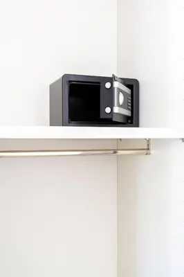 a microwave sitting on top of a white shelf at E.R. Apartment in Palermo