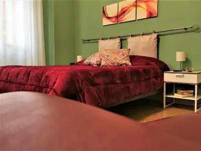 a bedroom with a bed with a stuffed animal on it at Elerà holiday apartment in Palermo