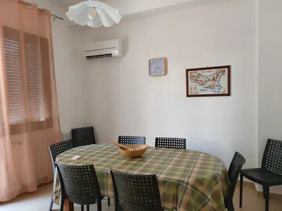 a dining room table with chairs and a bowl on it at Casa Lidia in Castellammare del Golfo