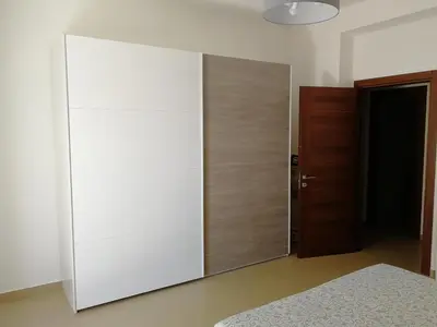 a large mirror in a bedroom with a bed at Casa Lidia in Castellammare del Golfo