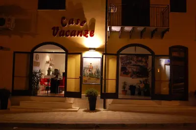a sign on the side of a building with a cafe warehouse at Sosta dei Garibaldini in Campofelice di Roccella