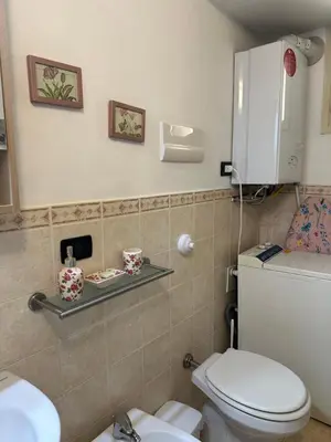 a bathroom with a toilet and a sink at VUCCIRIA 57 locazione turistica nel cuore pulsante della movida! in Palermo