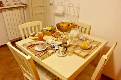 a dining room table with food on it at VUCCIRIA 57 locazione turistica nel cuore pulsante della movida! in Palermo