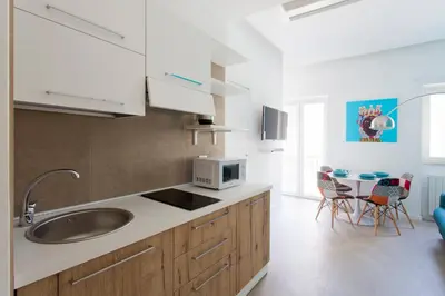 a kitchen with a sink and a microwave at Stabile Central Studios in Palermo