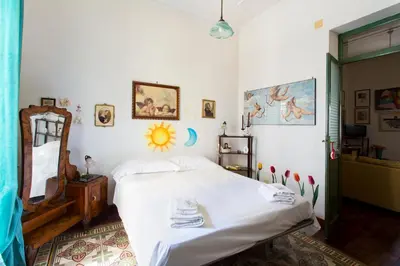 a bedroom with a bed and a mirror at Maison Tulip in Palermo