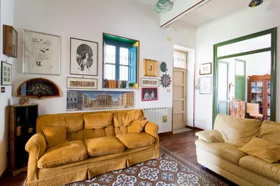 a living room with a couch and a window at Maison Tulip in Palermo