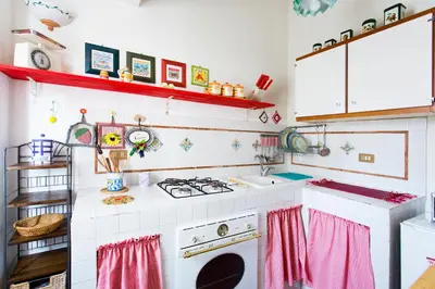 a kitchen with a stove and a sink at Maison Tulip in Palermo