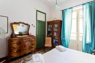 a bedroom with a mirror and a dresser and a window at Maison Tulip in Palermo