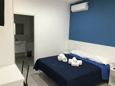 a bedroom with a bed with towels on it at La Ruota B&B in Terrasini