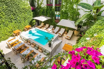 an overhead view of a pool with chairs and umbrellas at Casa Nostra Boutique Hotel & Spa in Palermo