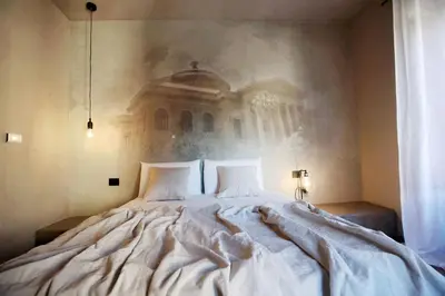 a bedroom with a large bed with two pillows at Casa Nostra Boutique Hotel & Spa in Palermo