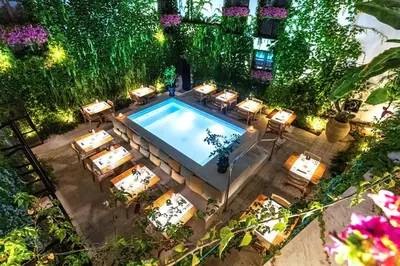 an overhead view of a pool with tables and chairs at Casa Nostra Boutique Hotel & Spa in Palermo