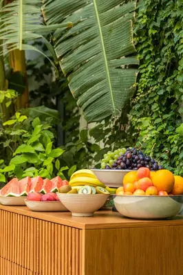 a bunch of bowls of fruit on a table at Casa Nostra Luxury Suites & Spa in Palermo