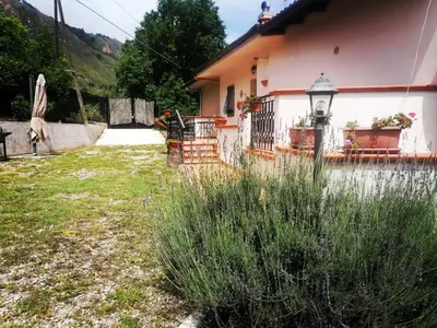 a house with a fence and a yard at L'Opuntia sul lago in Caccamo