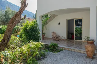 a porch of a house with a table and chairs at Isabel House in Isola delle Femmine