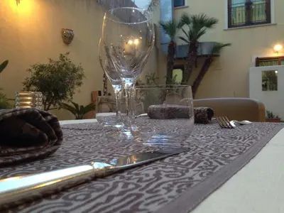 a table with wine glasses and a knife and fork at Zingaro Hotel in San Vito lo Capo