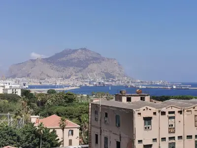 a view of a city with a mountain in the background at CasaMare Sant'Erasmo Sea View apartment & suites in Palermo