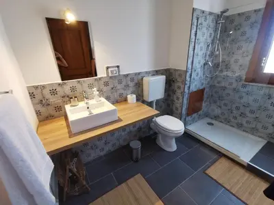a bathroom with a sink and a toilet and a shower at CasaMare Sant'Erasmo Sea View apartment & suites in Palermo