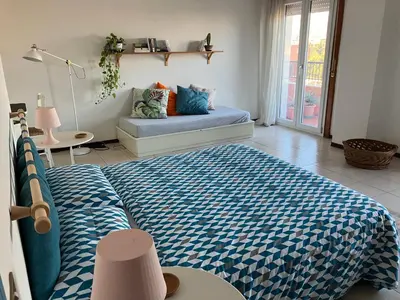 a bedroom with a bed and a couch in a room at CasaMare Sant'Erasmo Sea View apartment & suites in Palermo