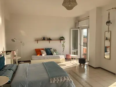 a bedroom with a bed and a couch in a room at CasaMare Sant'Erasmo Sea View apartment & suites in Palermo